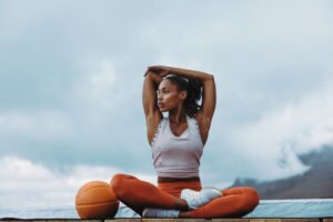 healthy woman taking break from workout on rooftop