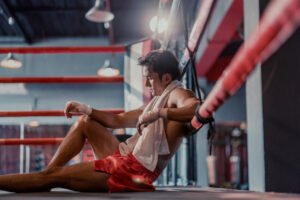 professional boxer feels exhausted, fatigued after putting up intense effort and discipline while following a training schedule. strict diets that help with physical fitness also lead to burnout.