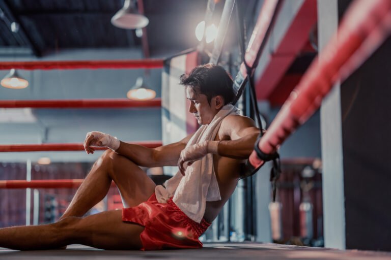 professional boxer feels exhausted, fatigued after putting up intense effort and discipline while following a training schedule. strict diets that help with physical fitness also lead to burnout.